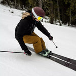 Volkl Women's Yumi 80 Skis 2024 - White skis with black bindings and a pink logo on the top of each ski.