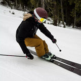 Volkl Women's Yumi 80 Skis 2024 - White skis with black bindings and a pink logo on the top of each ski.