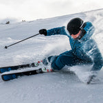 Völkl Mantra 88 Flat Skis 2025 - A pair of black skis with blue accents and a white logo on the top sheet, lying flat in snow.