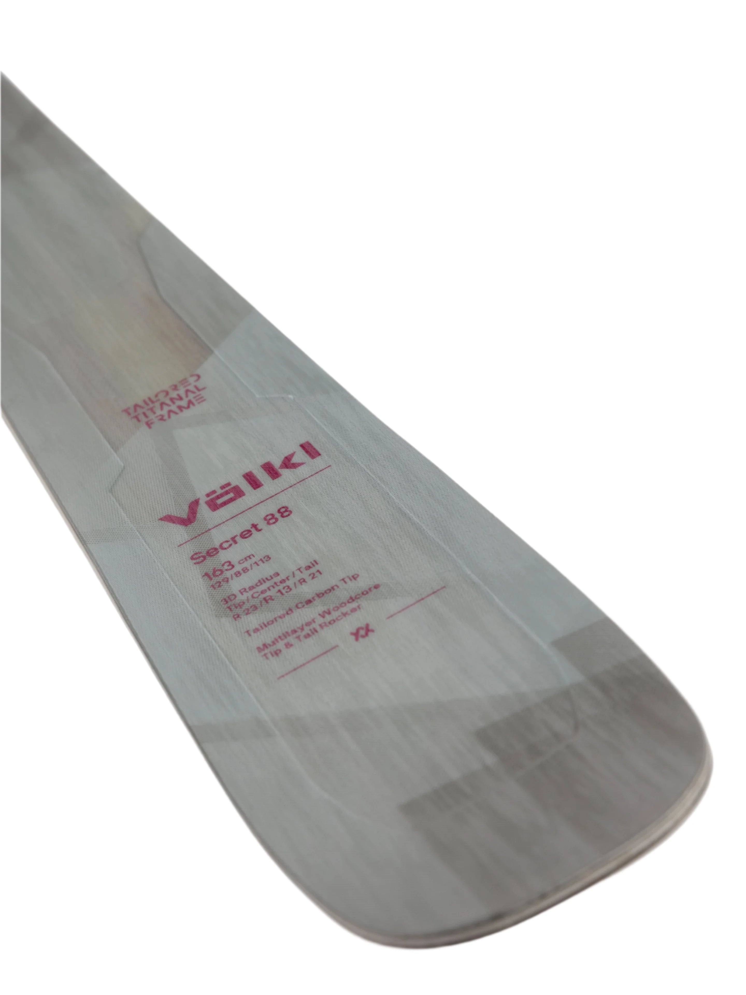 Völkl Women's Secret 88 Flat Skis 2025 - White skis with a subtle wood grain pattern on top and bottom, featuring a distinctive red logo near the tip.
