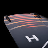 Hyperlite Baseline Wakeboard 2024 - A dark gray wakeboard with a white "H" logo on top and a red stripe along the bottom edge.