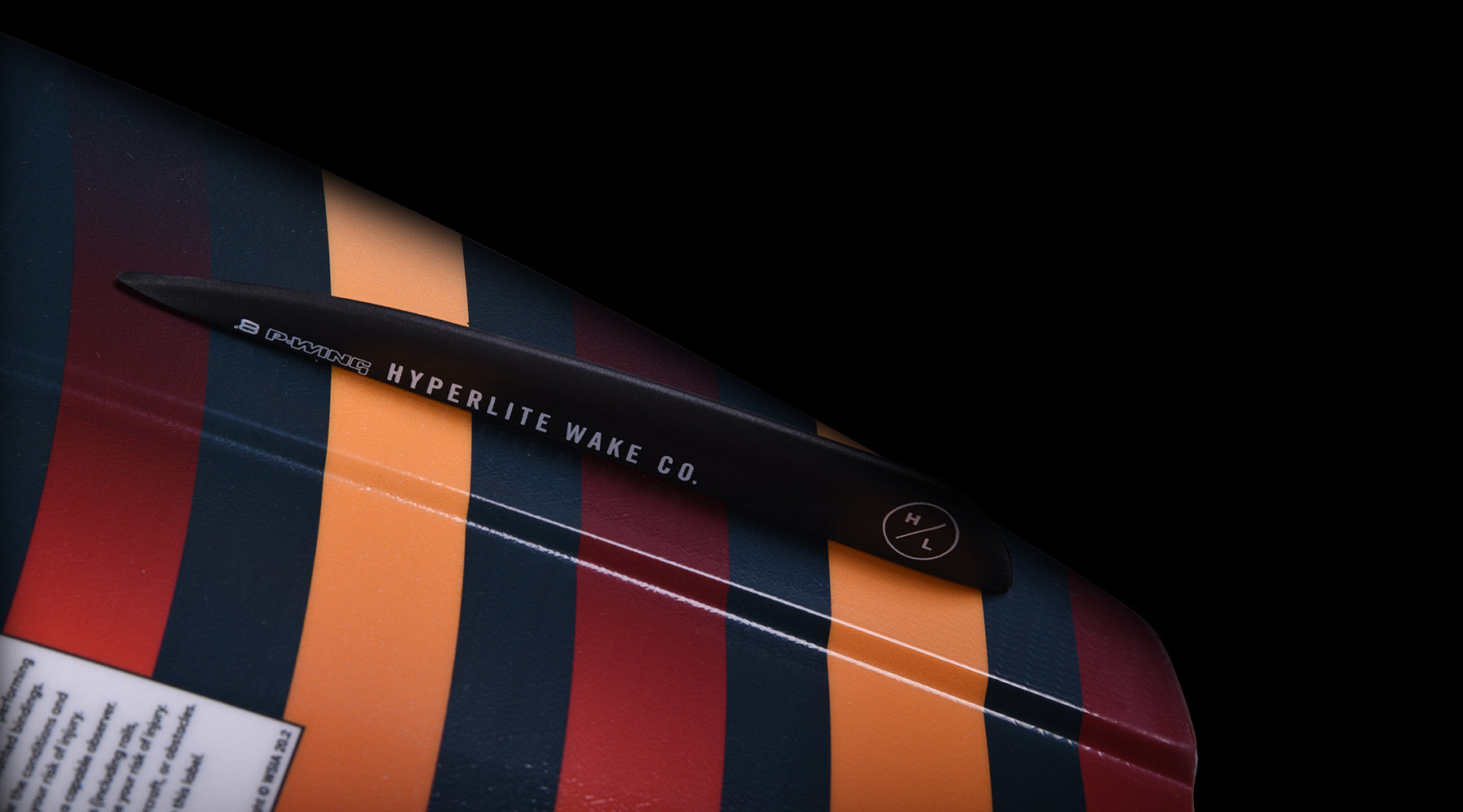 Hyperlite Baseline Wakeboard 2024 - A black wakeboard with white lettering and a logo on the top deck.