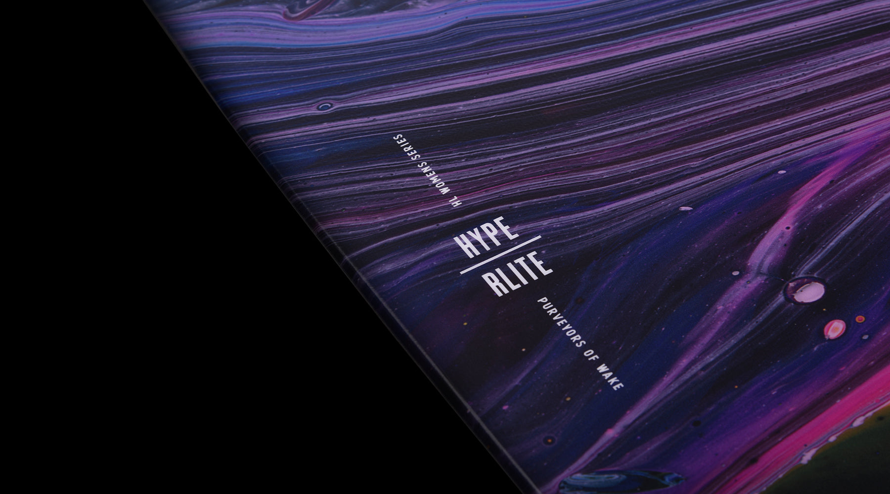 Hyperlite - Women's Prizm Wakeboard 2024 with a purple and blue marbled pattern on top, featuring a white logo in the upper left corner.