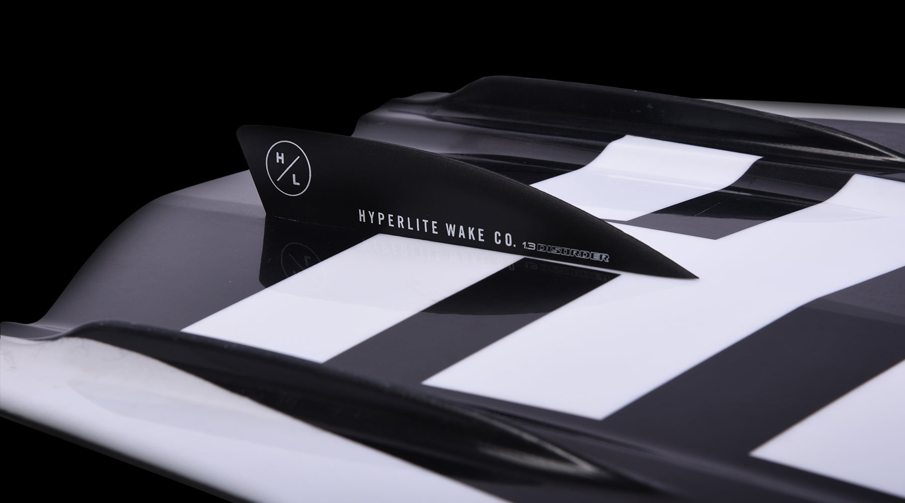 Hyperlite - Junior's State 2.0 Package 2024 is shown in a black and white image, featuring a close-up of the board's top surface with a diagonal stripe pattern.
