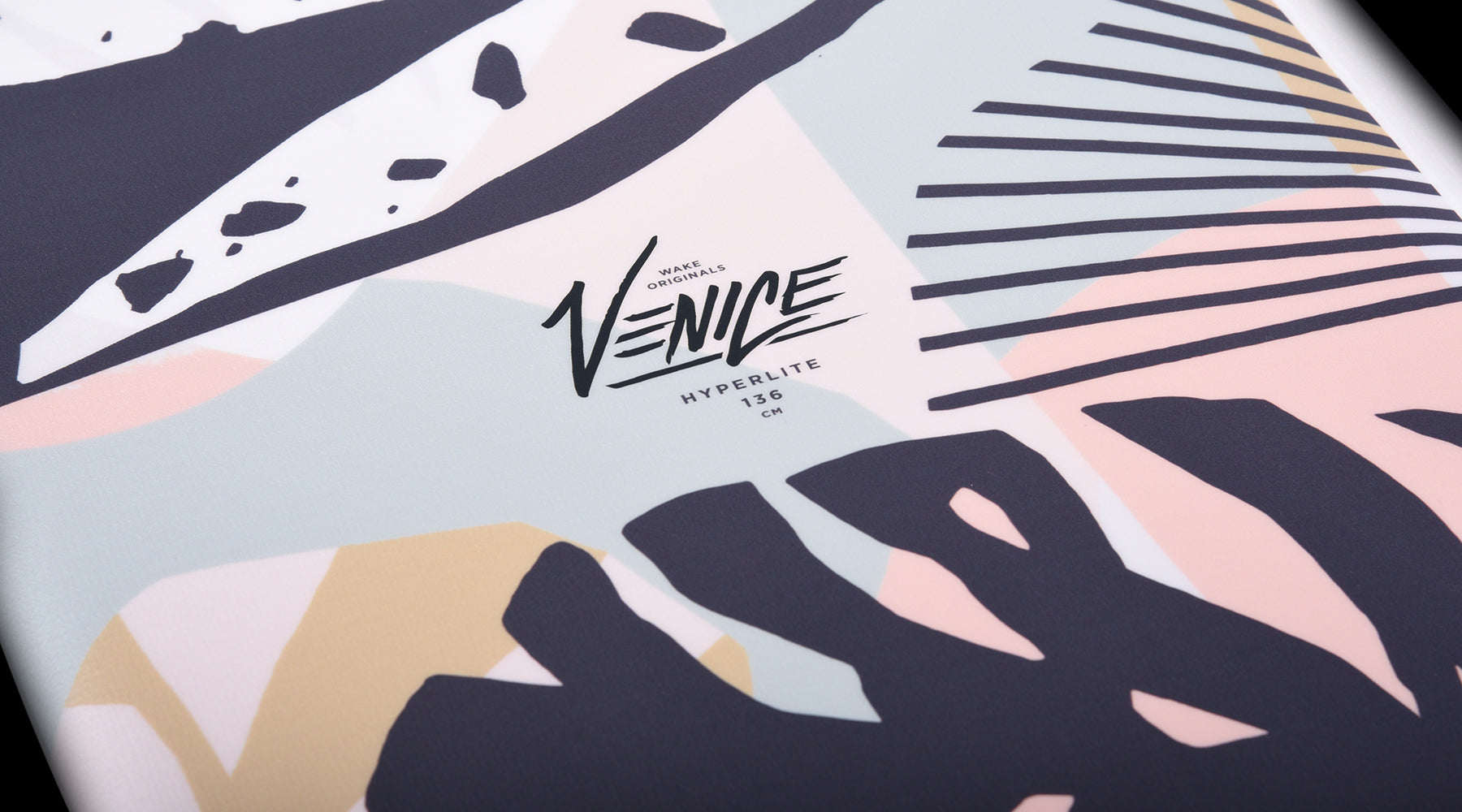 Hyperlite Venice - A white wakeboard with a light blue graphic of a palm tree and abstract shapes, featuring dark gray accents.