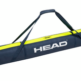 Head Double 175cm Ski Bag 2024 - A navy blue ski bag with a yellow stripe and black straps, featuring the word "HEAD" in white letters on one side.