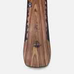Jones Women's Flagship Snowboard 2024 - A snowboard with a black and white logo on the top, featuring a mountain range design.