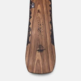 Jones Women's Flagship Snowboard 2024 - A snowboard with a black and white logo on the top, featuring a mountain range design.