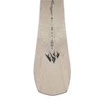 Jones Women's Flagship Snowboard 2025 - A light-colored snowboard with a black logo featuring three pointed shapes resembling mountains, positioned near the bottom of the board.