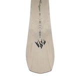 Jones Women's Flagship Snowboard 2025 - A light-colored snowboard with a black logo featuring three pointed shapes resembling mountains, positioned near the bottom of the board.