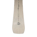Jones Women's Flagship Snowboard 2025 - A light-colored snowboard with a black logo on top and a black stripe down the middle.