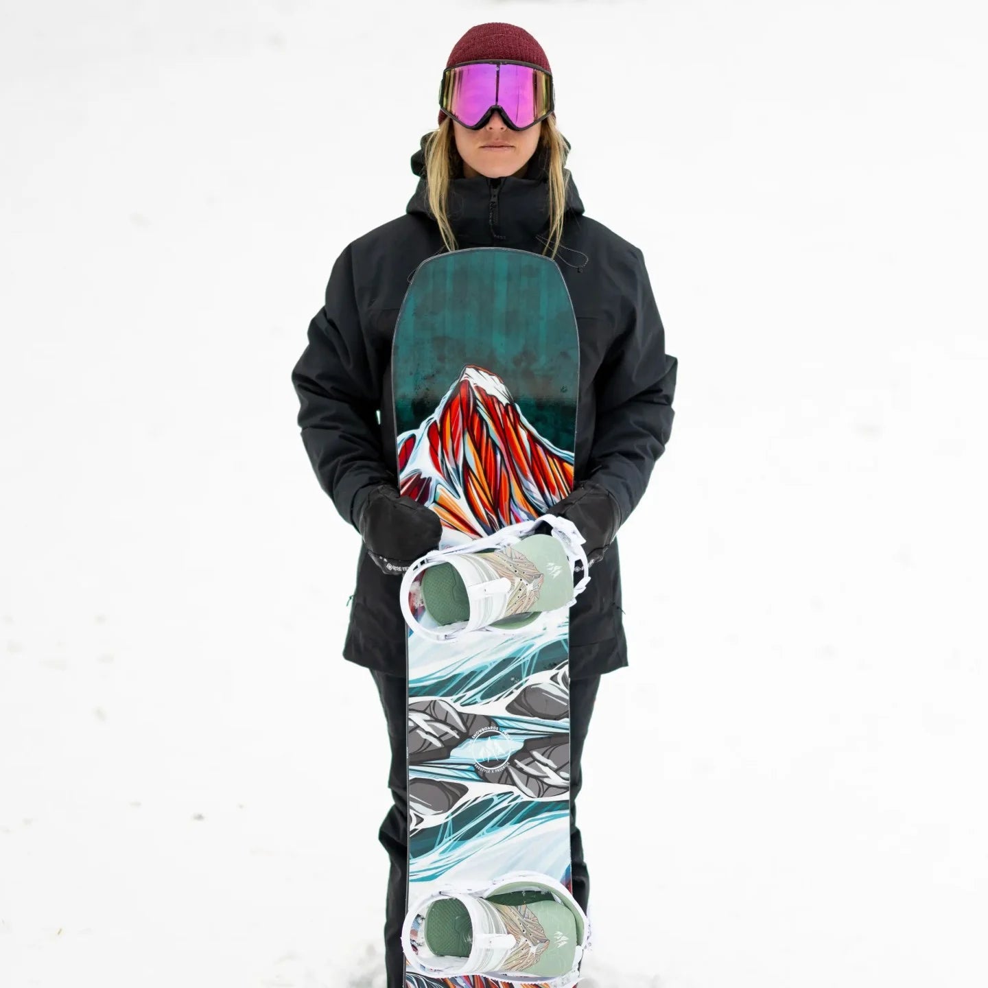 Jones Women's Twin Sister Snowboard 2025 - A snowboard with a white base and blue, red, and black abstract design on top.