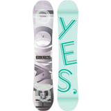 The Yes Emoticon Women's Snowboard 2023 is shown in light blue with large mint green letters spelling 'YES' running vertically down the center.