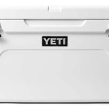 Yeti Tundra 65 Cooler - A large, white cooler with a black handle on top and a silver latch in the middle.