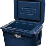 Yeti Tundra 35 Hard Cooler - A navy blue cooler with a raised "YETI" logo on its lid.