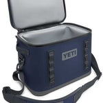 Yeti Hopper Flip 18 Personal Cooler - A navy blue cooler with a zippered lid and two handles on either side, featuring the word "YETI" in gray letters on one of its sides.