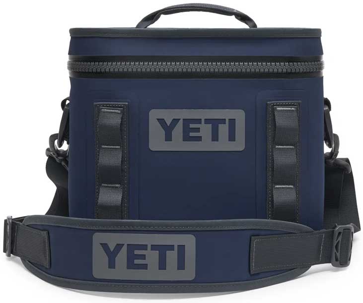 Yeti Hopper Flip 8 Personal Cooler - A navy blue cooler with a zippered top and two handles, featuring the word "YETI" in gray on one side.