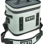 Yeti Hopper Flip 12 Personal Cooler - A light gray cooler with a dark gray zipper and handle, featuring a rectangular shape and a flat top.