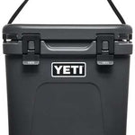 Yeti Roadie 24 Hard Cooler - A black cooler with a handle on top and two latches in front.