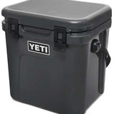 Yeti Roadie 24 Hard Cooler - A black, rectangular cooler with a handle on top and a latch in the middle.