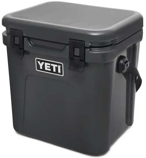 Yeti Roadie 24 Hard Cooler - A black, rectangular cooler with a handle on top and a latch in the middle.