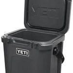 Yeti Roadie 24 Hard Cooler - A compact, portable cooler with a sleek design and a silver metal handle on top.