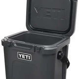 Yeti Roadie 24 Hard Cooler - A compact, portable cooler with a sleek design and a silver metal handle on top.