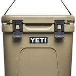 Yeti Roadie 24 Hard Cooler - A tan-colored cooler with a handle on top and two latches in front.