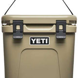 Yeti Roadie 24 Hard Cooler - A tan-colored cooler with a handle on top and two latches in front.