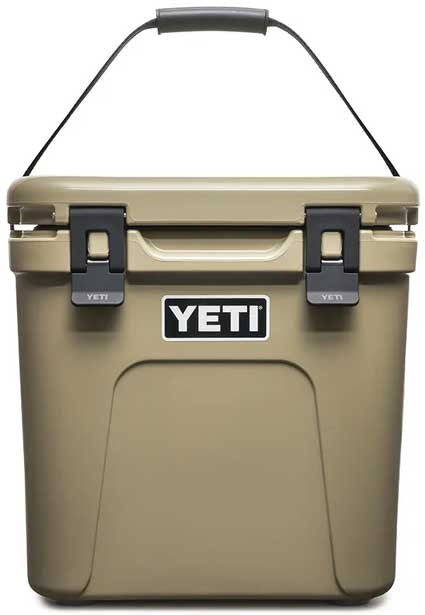 Yeti Roadie 24 Hard Cooler - A tan-colored cooler with a handle on top and two latches in front.