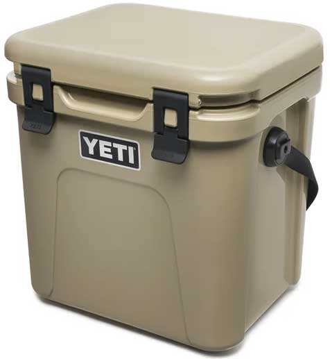 Yeti Roadie 24 Hard Cooler - A tan-colored cooler with a handle on one side and a latch on top.