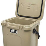 Yeti Roadie 24 Hard Cooler - A tan cooler with a black handle on the right side and a white logo that says "YETI" in all caps.
