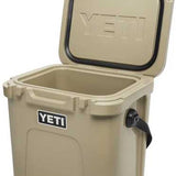 Yeti Roadie 24 Hard Cooler - A tan cooler with a black handle on the right side and a white logo that says "YETI" in all caps.