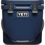 Yeti Roadie 24 Hard Cooler - A navy blue cooler with a handle on top and two latches, one on each side.