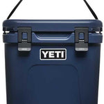 Yeti Roadie 24 Hard Cooler - A navy blue cooler with a handle on top and two latches in front.