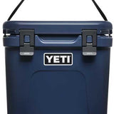 Yeti Roadie 24 Hard Cooler - A navy blue cooler with a handle on top and two latches in front.