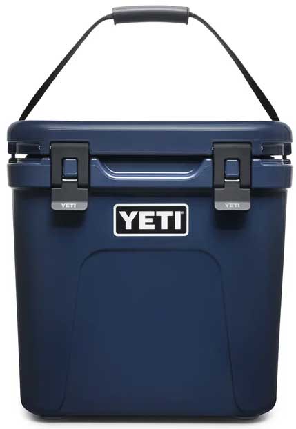 Yeti Roadie 24 Hard Cooler - A navy blue cooler with a handle on top and two latches in front.