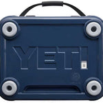 Yeti Roadie 24 Hard Cooler - A navy blue cooler with a handle on top and four round feet, featuring the word "YETI" embossed in large letters on its side.