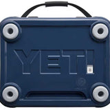Yeti Roadie 24 Hard Cooler - A navy blue cooler with a handle on top and four round feet, featuring the word "YETI" embossed in large letters on its side.