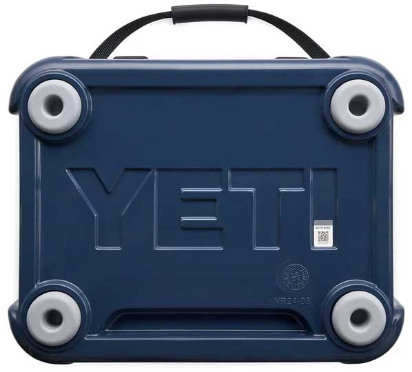 Yeti Roadie 24 Hard Cooler - A navy blue cooler with a handle on top and four round feet, featuring the word "YETI" embossed in large letters on its side.