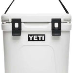 Yeti Roadie 24 Hard Cooler - A white cooler with a black handle on top and a black logo that says "YETI" in bold letters.