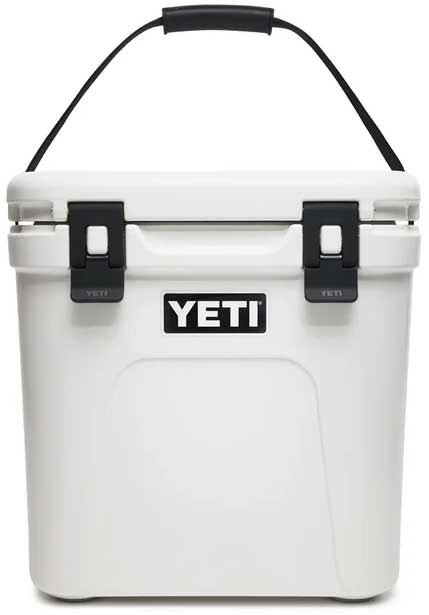 Yeti Roadie 24 Hard Cooler - A white cooler with a black handle on top and a black logo that says "YETI" in bold letters.