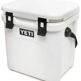 Yeti Roadie 24 Hard Cooler - A white, rectangular cooler with a flat top and rounded corners, featuring two black latches on its lid.