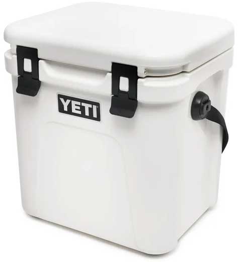 Yeti Roadie 24 Hard Cooler - A white, rectangular cooler with a flat top and rounded corners, featuring two black latches on its lid.