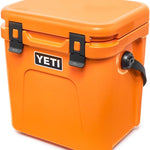 Yeti Roadie 24 Hard Cooler - A compact, portable cooler with a sleek design and a silver handle on top.