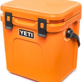 Yeti Roadie 24 Hard Cooler - A compact, portable cooler with a sleek design and a silver handle on top.