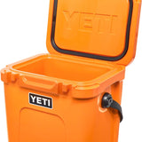 Yeti Roadie 24 Hard Cooler - A compact, portable cooler with a sleek design and a silver metal handle on top.