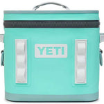 Yeti Hopper Flip 12 Personal Cooler - A light blue cooler with a zippered lid and two handles on either side, featuring a prominent "YETI" logo in white lettering on the front.