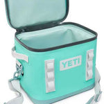 Yeti Hopper Flip 12 Personal Cooler - A mint green cooler with a zippered lid and two gray handles on either side.