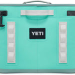 Yeti Hopper Flip 18 Personal Cooler - A mint green cooler with a handle on top and an ice pack visible inside.